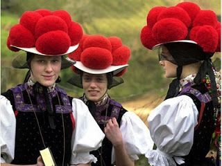 Red bobbles on hats. Girls with red pompom hats.